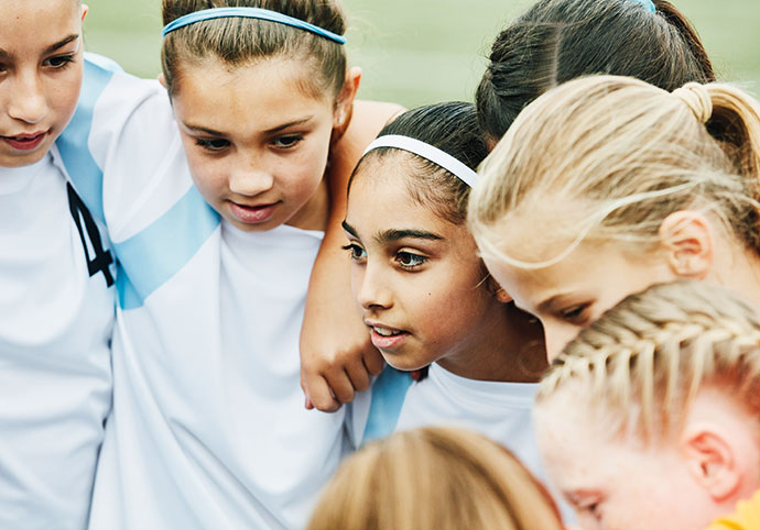 Sechs junge Sportlerinnen stehen eng zusammen