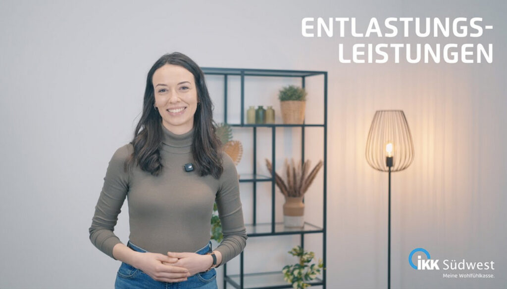 Eine lächelnde Frau steht im Innenbereich neben einer brennenden Stehlampe und einem Regal mit Pflanzen. Über ihr steht in großen Buchstaben „Entlastungsleistungen“, in der unteren rechten Ecke ist das Logo der IKK Südwest zu sehen.